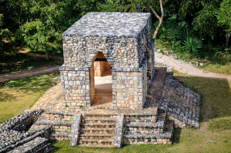 Corbel-vaulted gateway at the entrance to Ek' Balam's walled ceremonial core, revealing inner chamber and flanking steps
