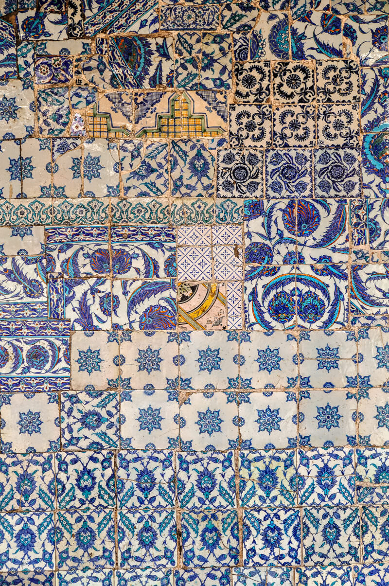Close view of exterior Iznik tiles at Rustem Pasha Mosque with tulip, carnation, and saz-leaf motifs in blue and red