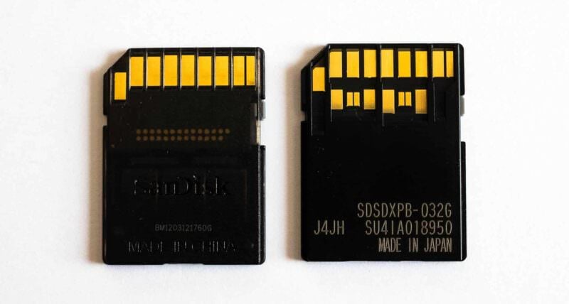 Side-by-side shot of the contacts of SD Cards. On the left is a UHS-1 card. On the right is a UHS-II card.