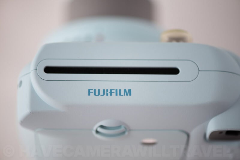 Top view of the Instax Mini 8 showing the film ejection slot above the Fujifilm logo