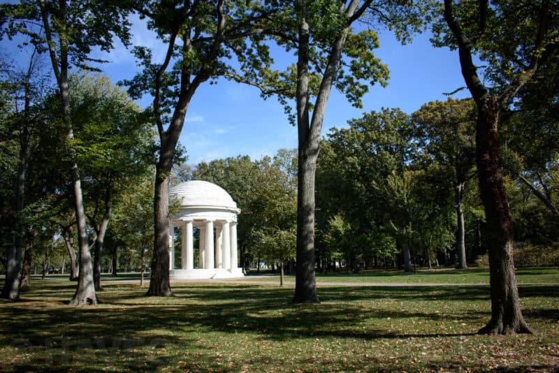 District of Columbia War Memorial rotunda framed by tall trees in a park setting