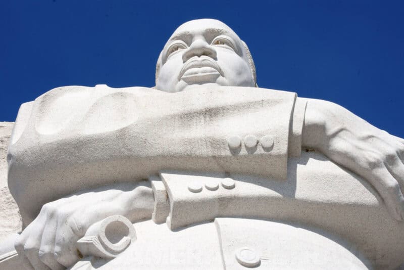 Martin Luther King Jr Memorial statue, close view of the carved stone face and folded arms