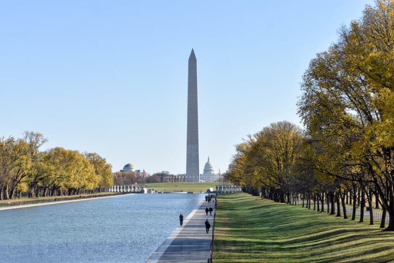 Washington Monument rising above the Reflecting Pool with the Capitol dome in the distance
