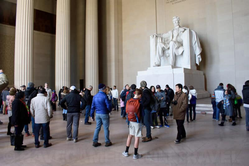 Visitors gathered before the Lincoln Memorial statue beneath its towering marble columns