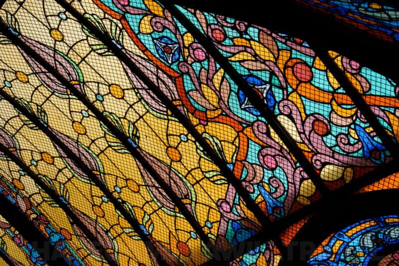 Detail of colorful Art Nouveau stained-glass ceiling panels in ornate geometric patterns