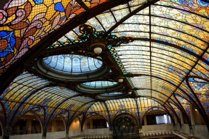 Ornate stained-glass domed ceiling of the Gran Hotel Ciudad de Mexico with arched glass panels