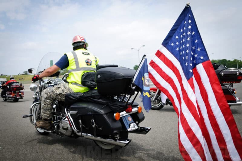 Motorcyclist with an American flag riding in the Rolling Thunder procession in Washington DC