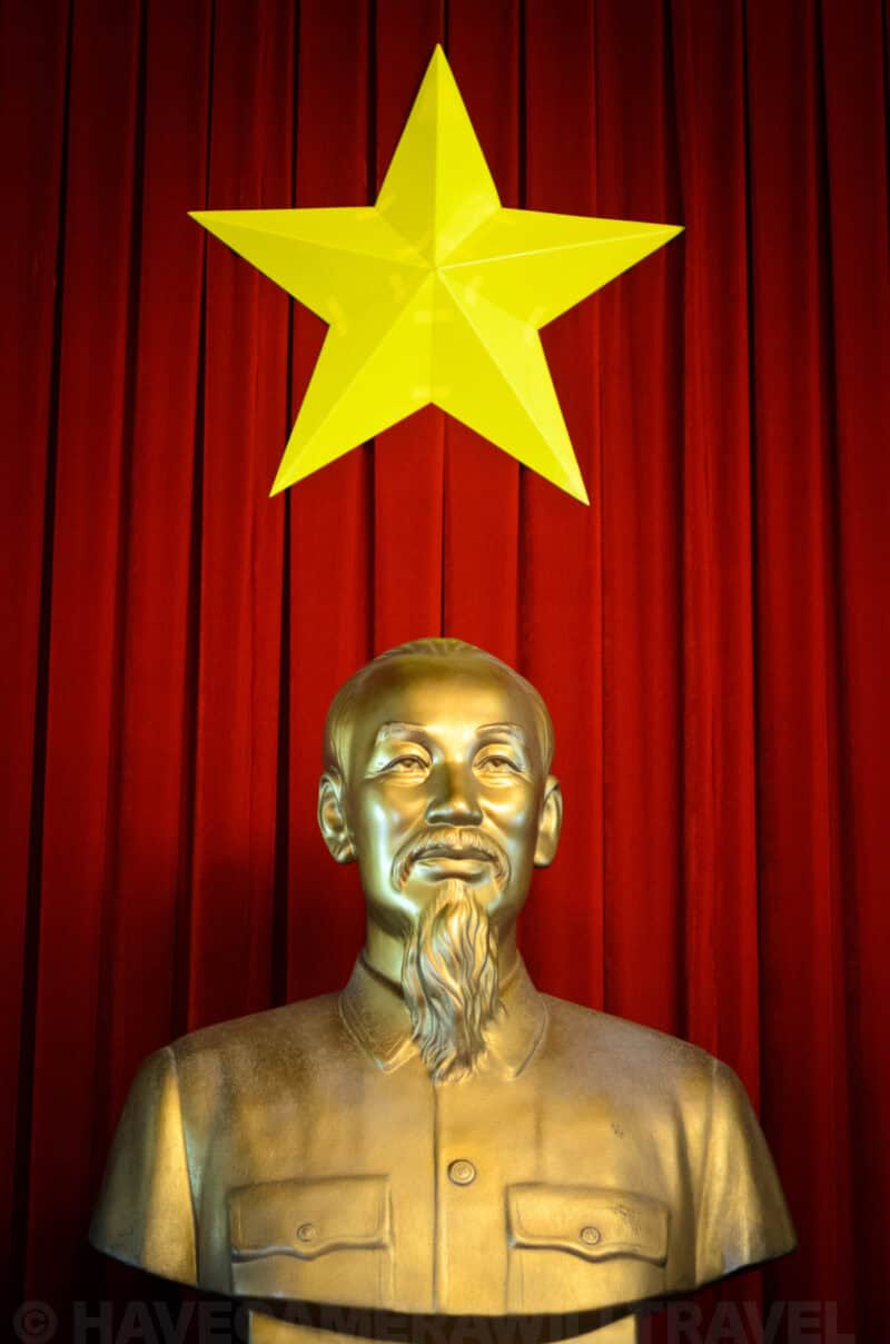 Golden bust of Ho Chi Minh beneath a yellow star inside Reunification Palace in Ho Chi Minh City