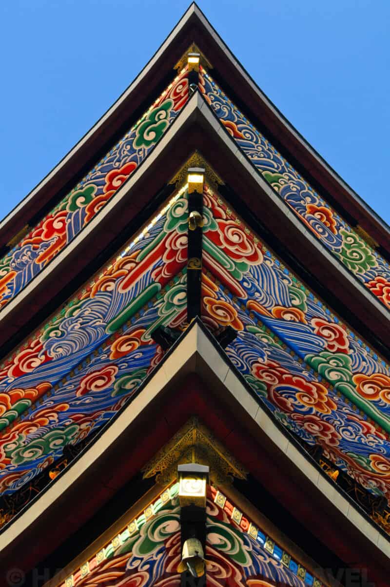 Close-up of colorful painted cloud patterns on a pagoda roof eave in Narita, Japan