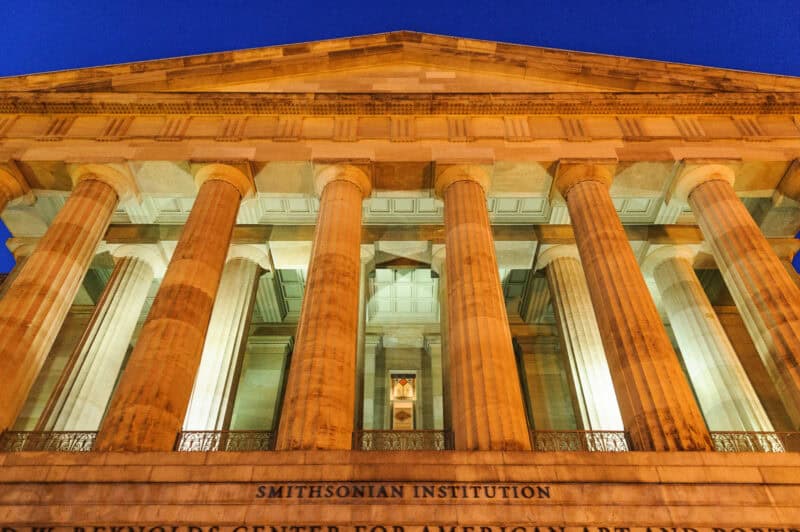 Corinthian columns of the Smithsonian Institution building illuminated at dusk