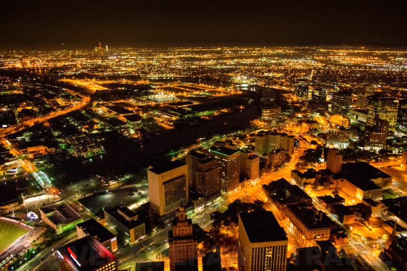 Nighttime aerial cityscape of Newark, New Jersey, with illuminated streets and skyline viewed from a helicopter
