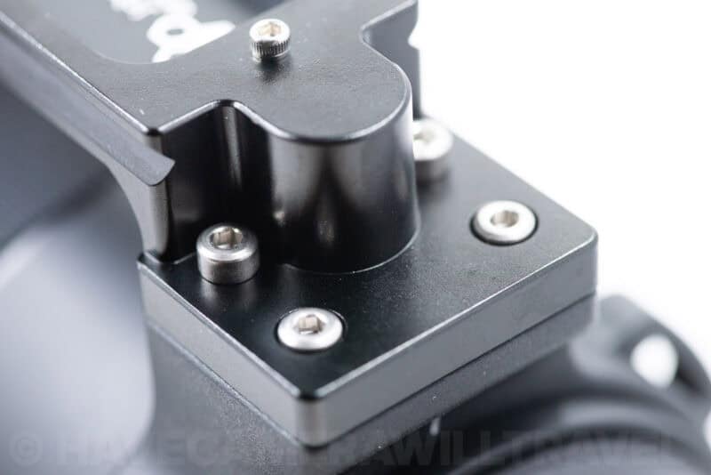 New Arca-style foot attached to the lens, showing screws seated at varying depths