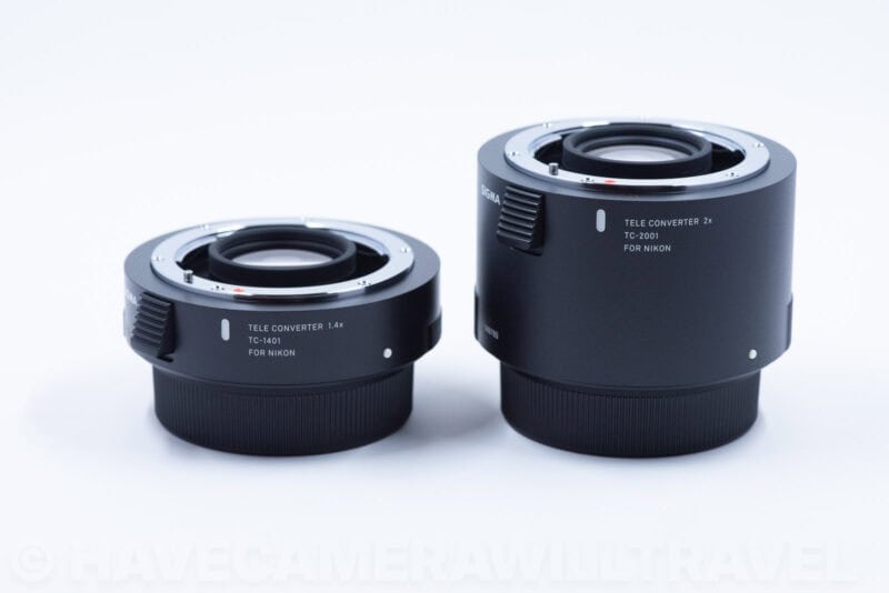 Sigma 1.4x and 2x teleconverters for Nikon shown side by side, the 2x noticeably larger