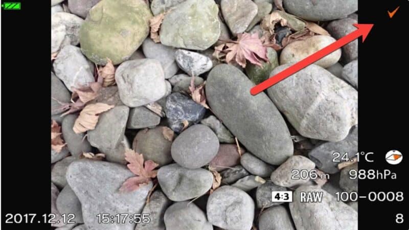 Olympus TG-5 image playback screen with orange checkmark marking a photo for multi-image protection
