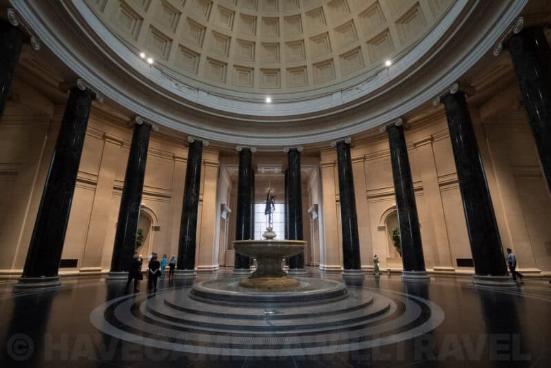 Domed rotunda of the National Gallery of Art with black marble columns encircling a fountain
