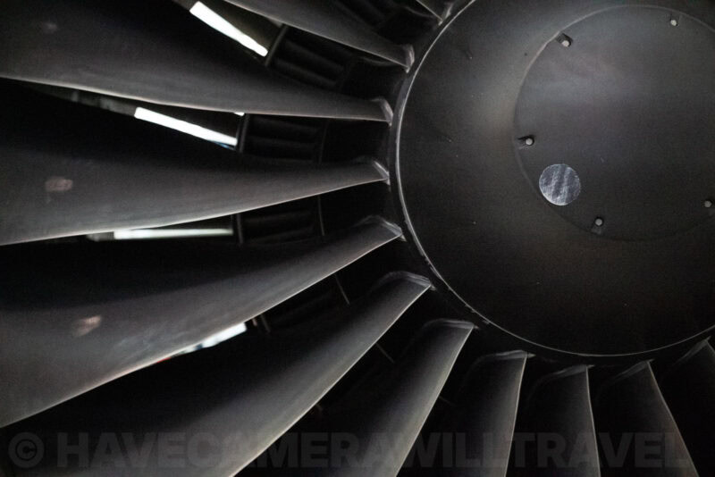 Close-up of a jet engine's angled fan blades and dark central hub