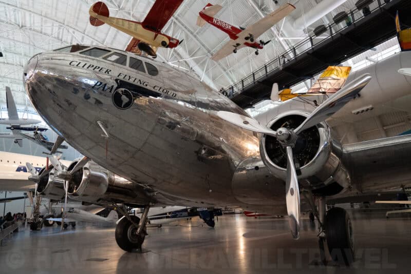 Polished silver Clipper Flying Cloud propliner nose and engine on display at a museum hangar