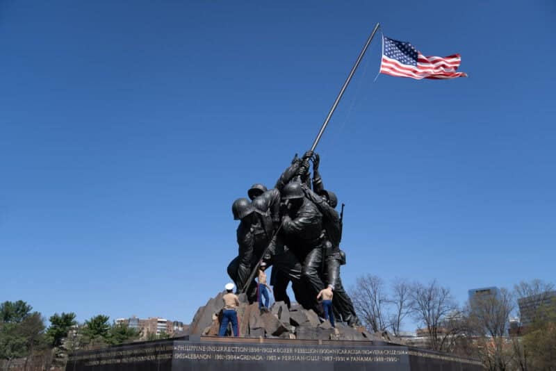 Iwo Jima Memorial bronze statue of Marines raising the American flag under a blue sky