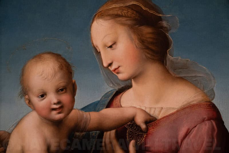 Close-up detail of Raphael's Madonna and Child painting showing the mother and infant's faces