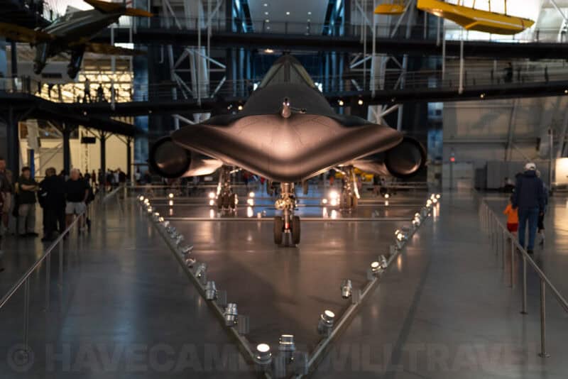 Lockheed SR-71 Blackbird spy plane displayed nose-on in a dimly lit museum hangar