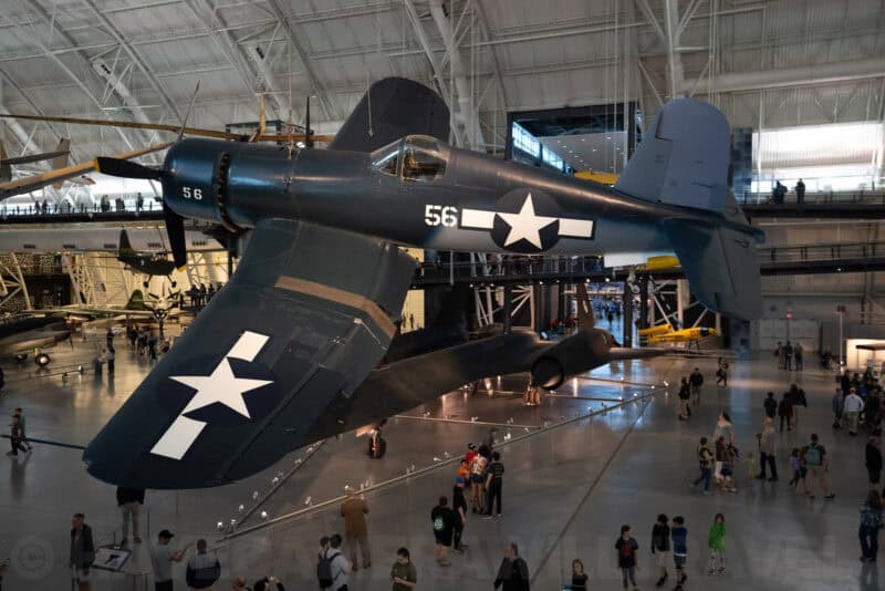 Vintage Navy fighter plane hanging overhead in the Udvar-Hazy Center aviation museum hangar