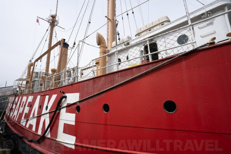 Red hull lettering and portholes of the Chesapeake lightship moored at the waterfront