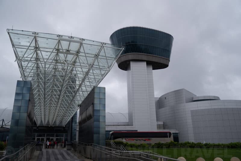 Udvar-Hazy Center entrance with glass canopy and observation tower under overcast sky