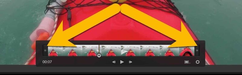 Lightroom trim tool with arrows showing the start and end handles being dragged inward on a kayak video