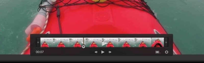 Close-up of Lightroom's video trim bar beneath a kayak clip, showing filmstrip thumbnails and play controls