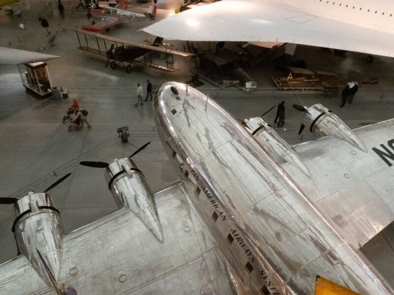Vintage Pan American Airways propeller plane nose viewed from above in a museum hall
