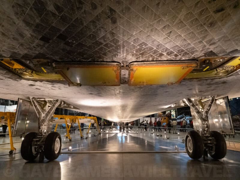 Underside view of the Space Shuttle showing its heat shield tiles and landing gear
