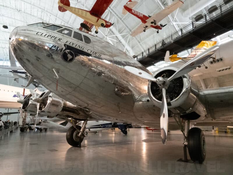 Vintage silver Clipper Flying Cloud aircraft displayed in a museum hangar