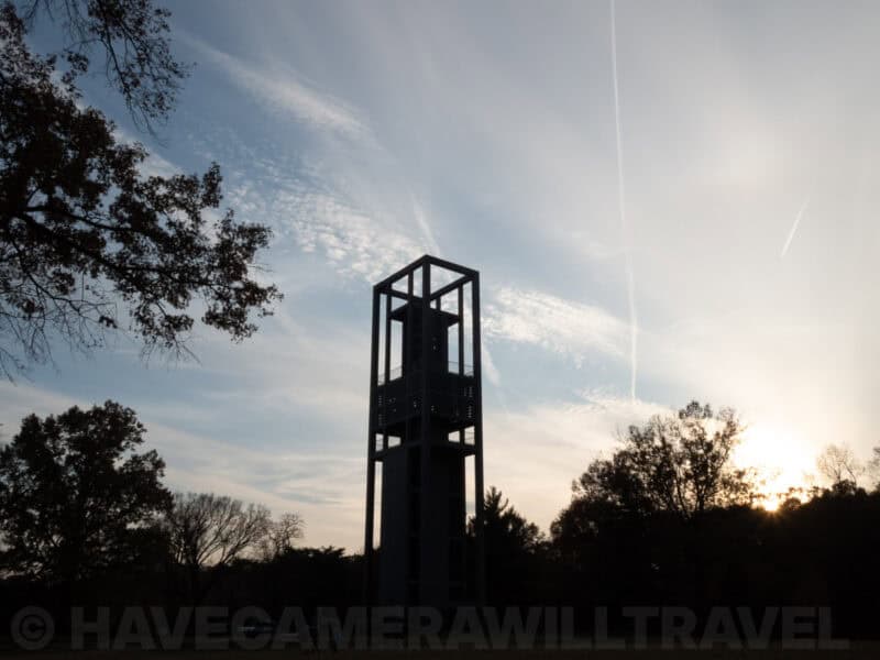 Silhouette of the Netherlands Carillon tower against a dramatic sky at dusk