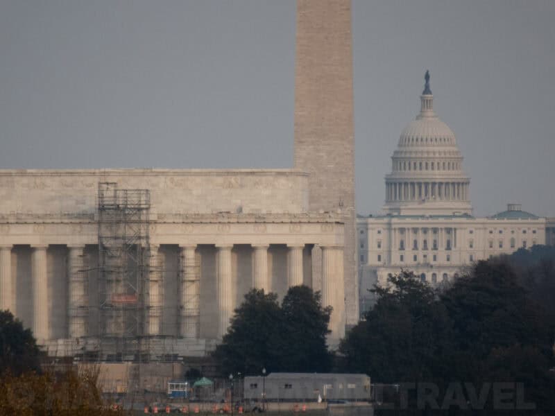 US Capitol dome and Jefferson Memorial rooftop seen across the water at a distance