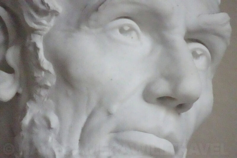 Extreme close-up of the Lincoln Memorial statue's carved marble eyes and nose