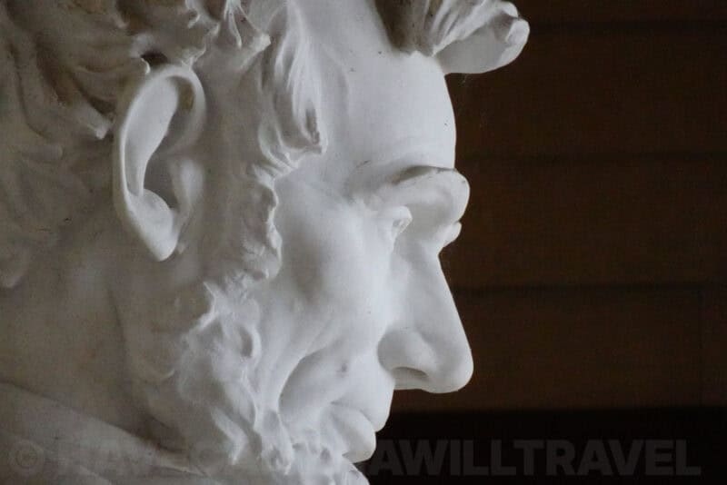 Close-up profile of the Lincoln Memorial statue's carved marble face and beard