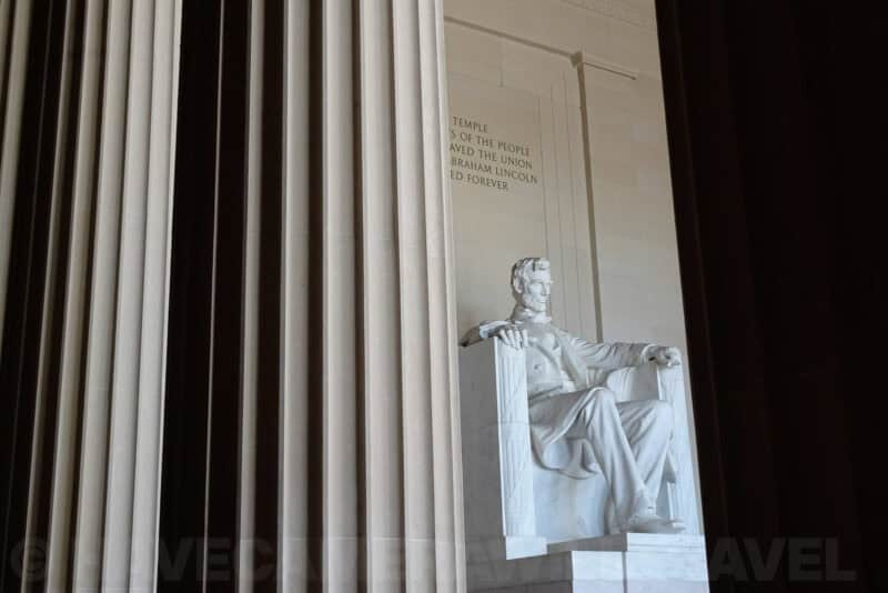 Abraham Lincoln statue viewed through the Lincoln Memorial's marble columns