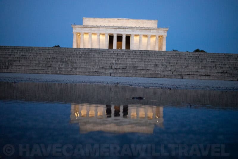 Lincoln Memorial at dusk reflected in the reflecting pool with its illuminated columns