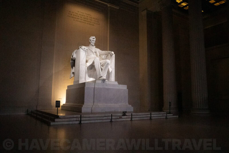 Lincoln Memorial statue glowing beneath the inscribed wall inside its marble hall