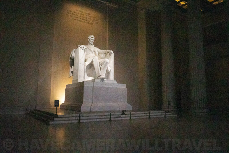 Lincoln Memorial statue lit at night within its towering marble chamber