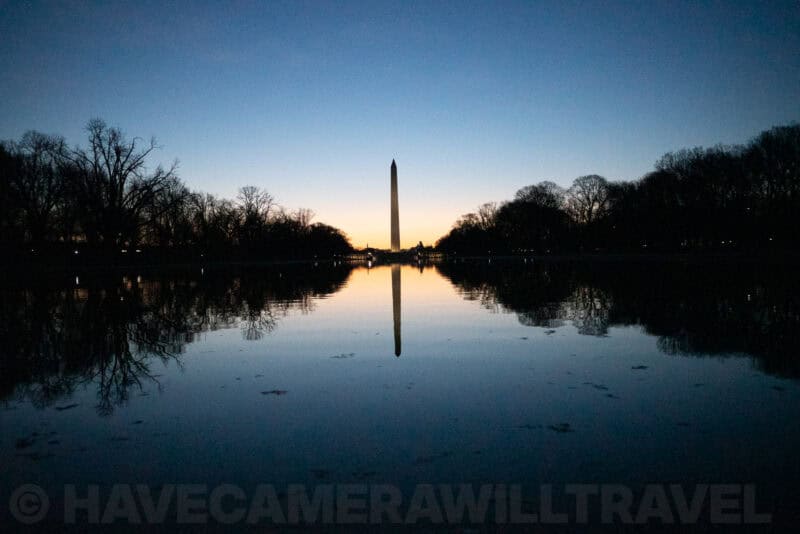 Washington Monument silhouette mirrored in the Reflecting Pool against a twilight sky