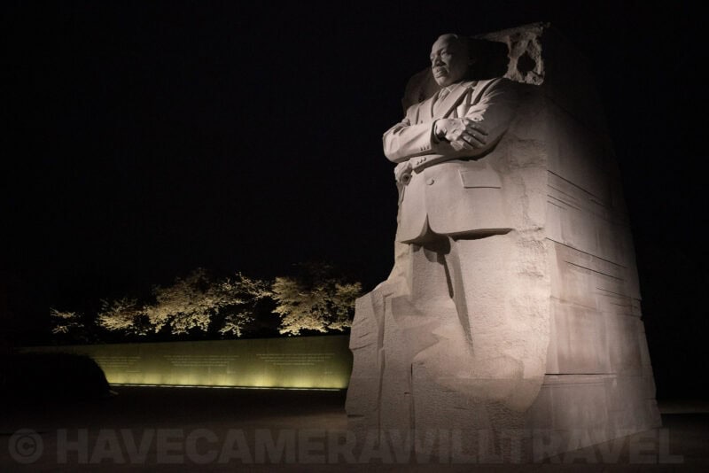 Martin Luther King Jr. Memorial statue lit up at night against a dark sky