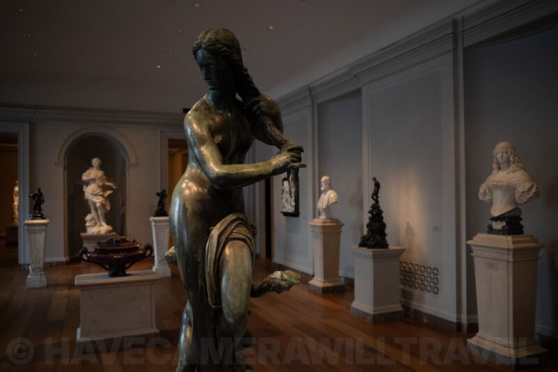 Bronze statue of a woman viewed from behind in a museum sculpture gallery