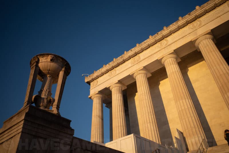 Lincoln Memorial columns and cornice lit warmly against a deep blue sky
