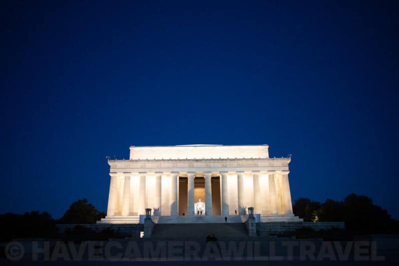 Lincoln Memorial illuminated against a deep blue night sky