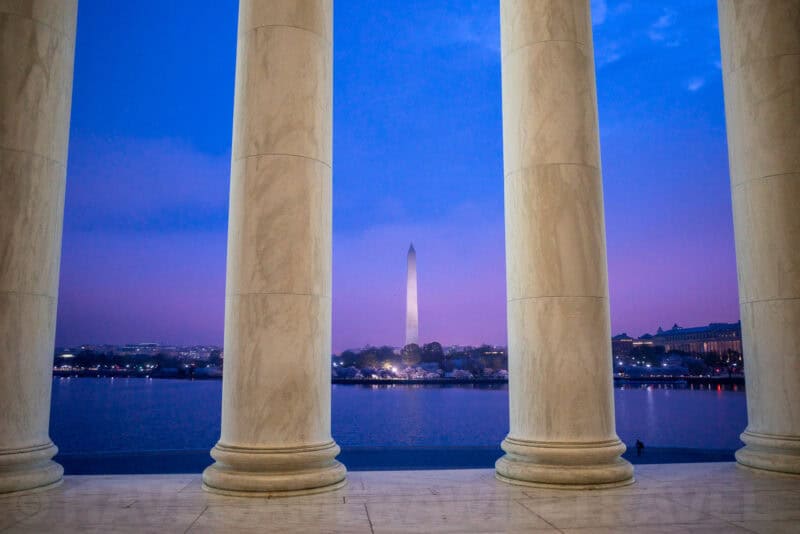 Washington Monument seen through the columns of the Jefferson Memorial at dusk