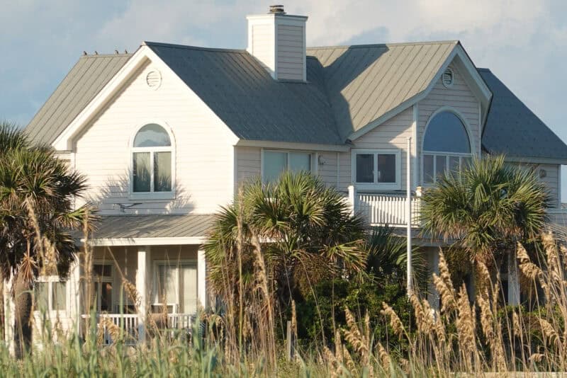 Coastal house with metal roof and palm trees shown using Clear Image Zoom