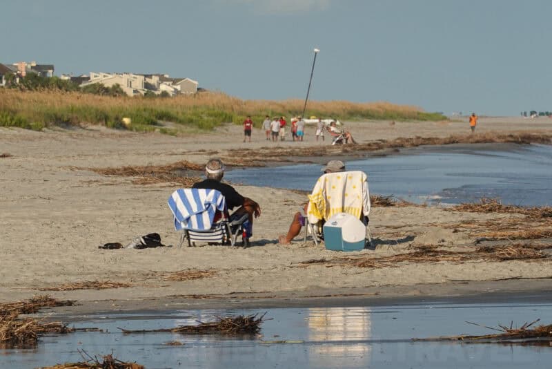 Beach chairs and seated couple by the water shown using Clear Image Zoom