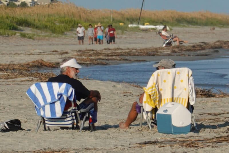 Close crop of two people in beach chairs with coolers using Digital Zoom