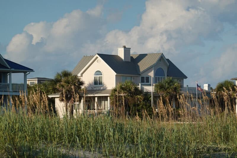 Beach house with palm trees and sea grass captured at 200mm optical zoom